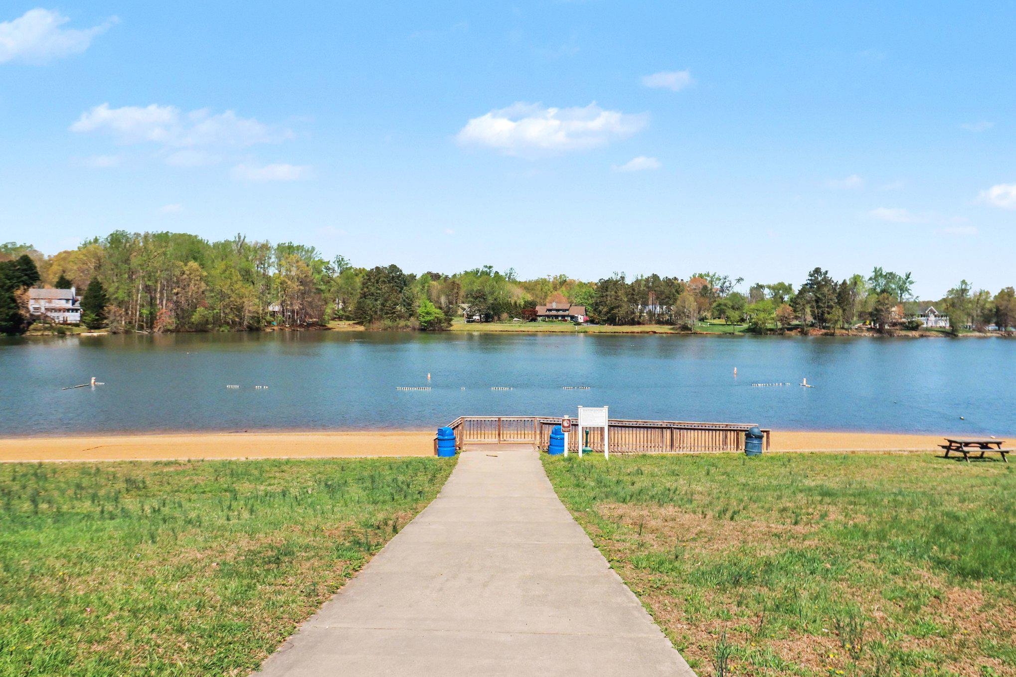 876 Campers Lane Ruther Glen, VA 22546 - Photo 25 of 27 a view of a lake with houses in the back