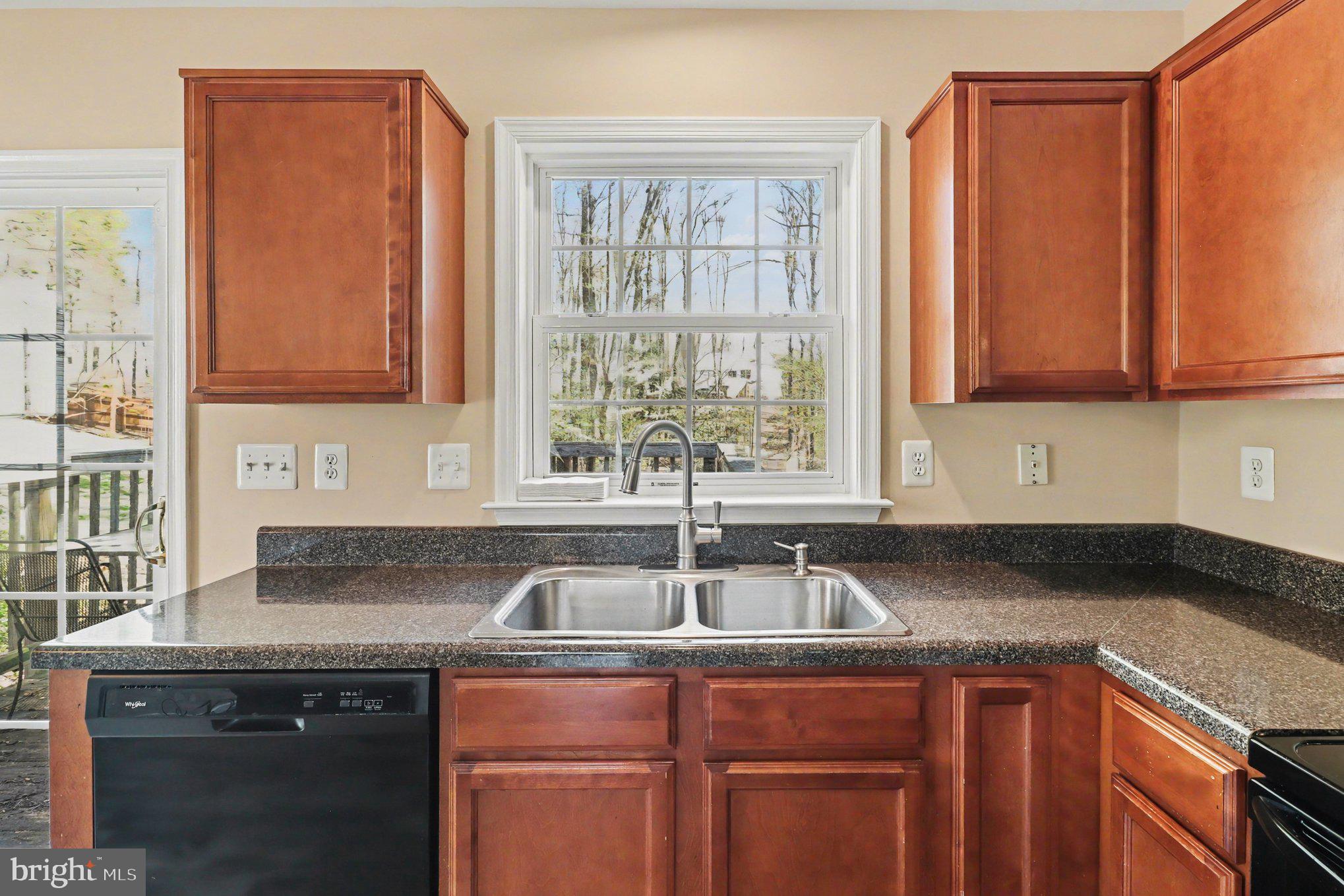 876 Campers Lane Ruther Glen, VA 22546 - Photo 5 of 27 a kitchen with granite countertop a sink and a window