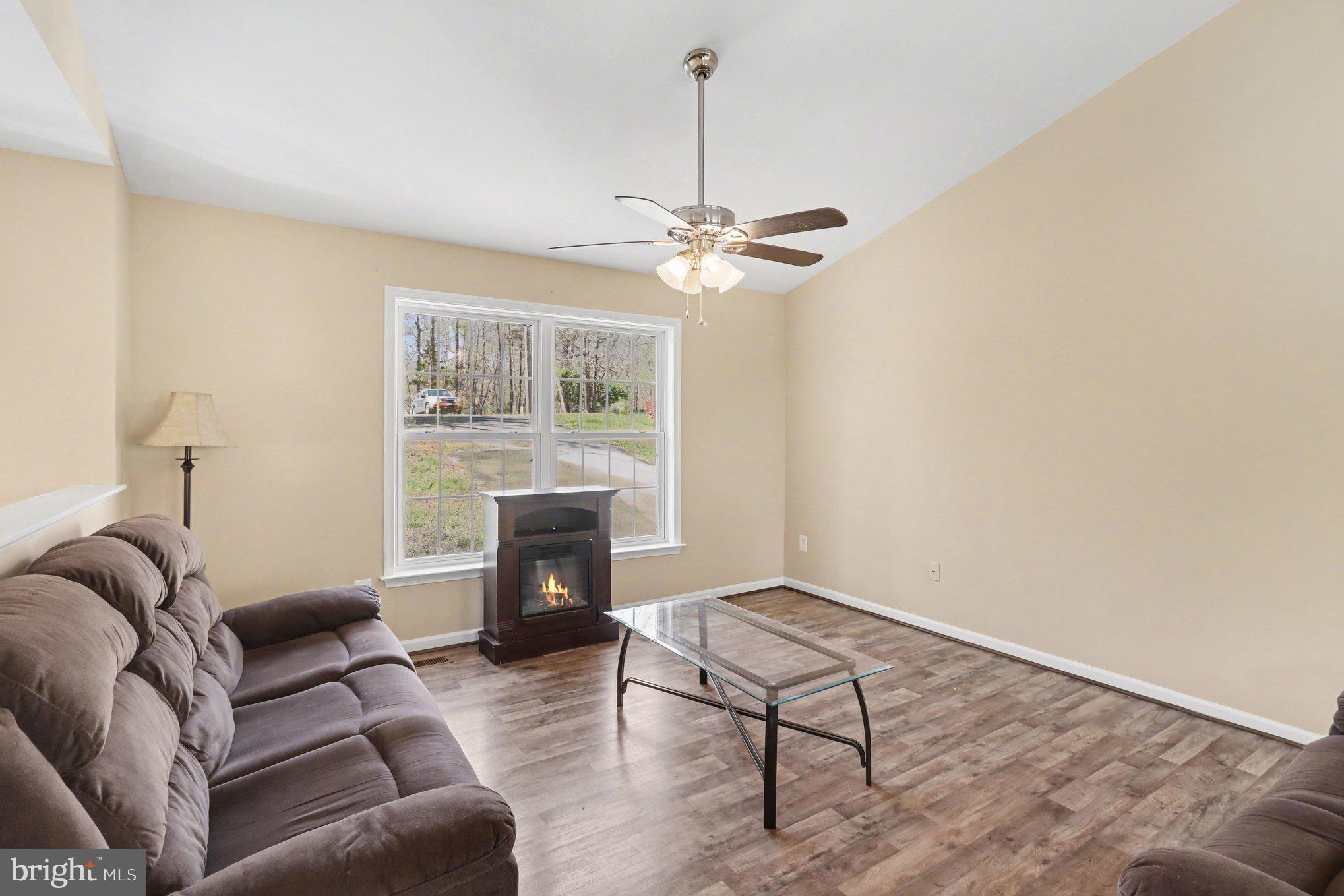 876 Campers Lane Ruther Glen, VA 22546 - Photo 7 of 27 a living room with furniture and a fireplace