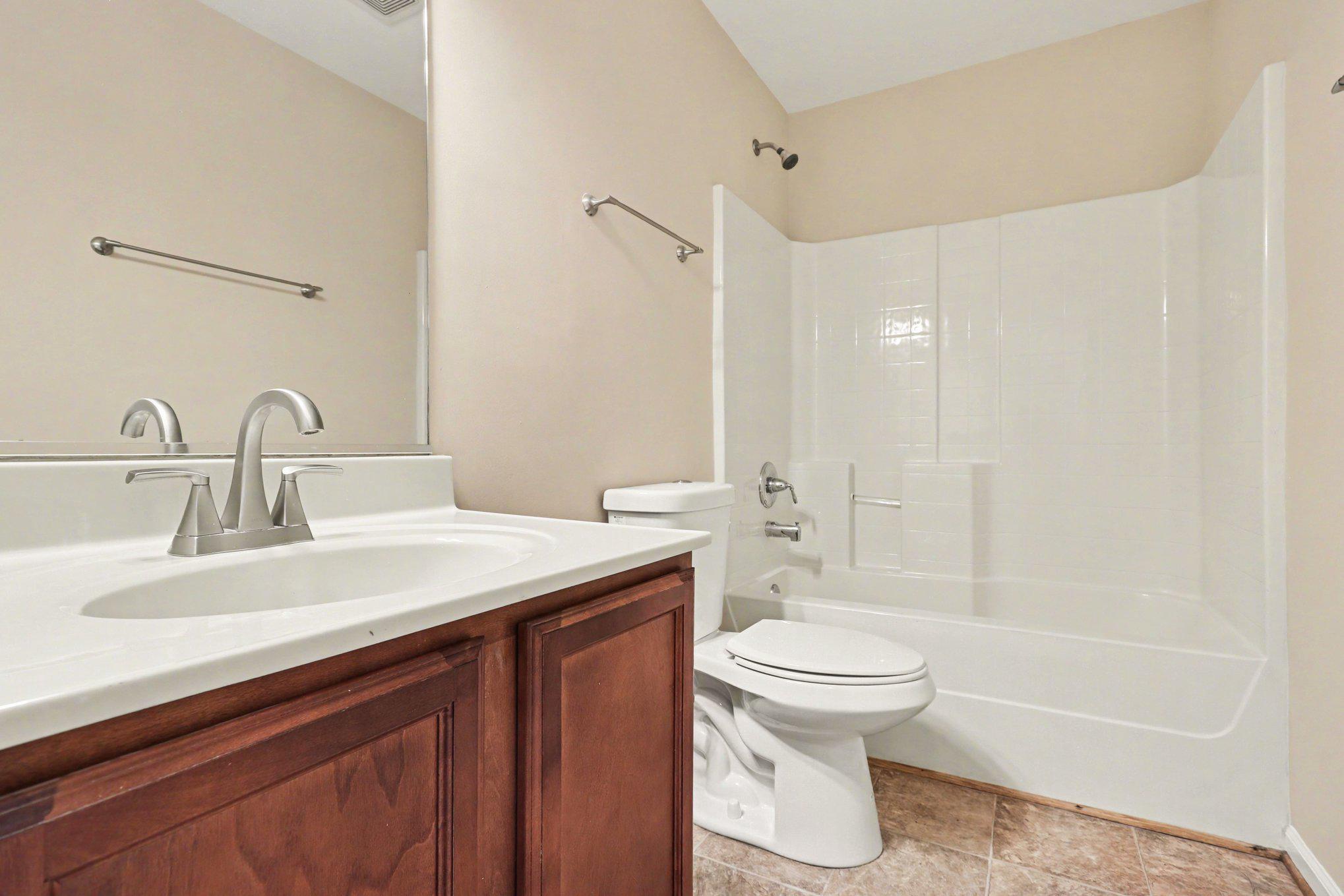 876 Campers Lane Ruther Glen, VA 22546 - Photo 9 of 27 a bathroom with a sink a toilet and a large mirror