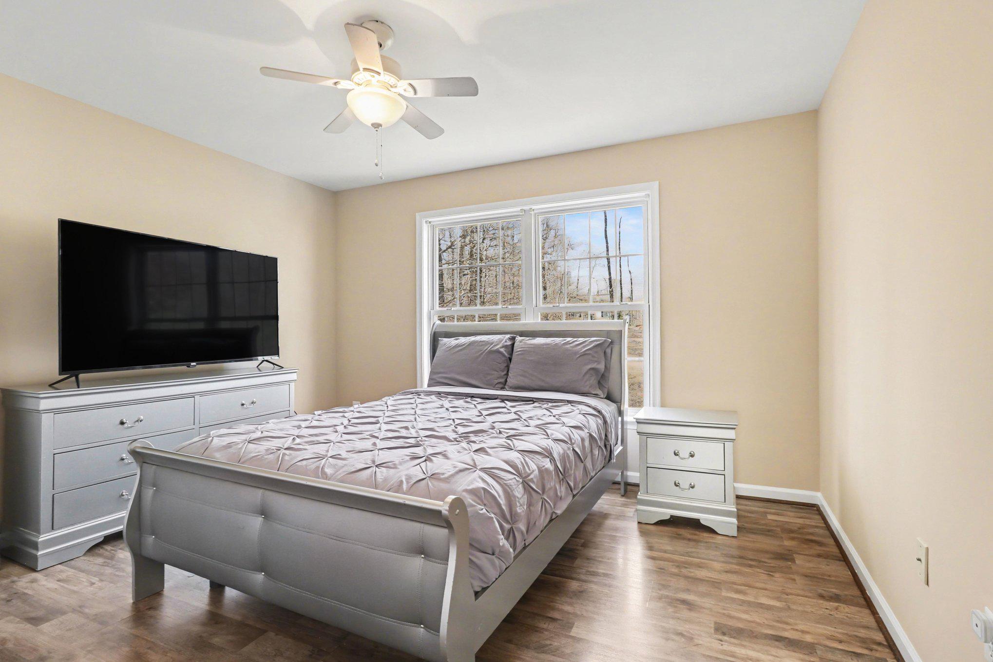 876 Campers Lane Ruther Glen, VA 22546 - Photo 10 of 27 a bedroom with a bed and a flat screen tv