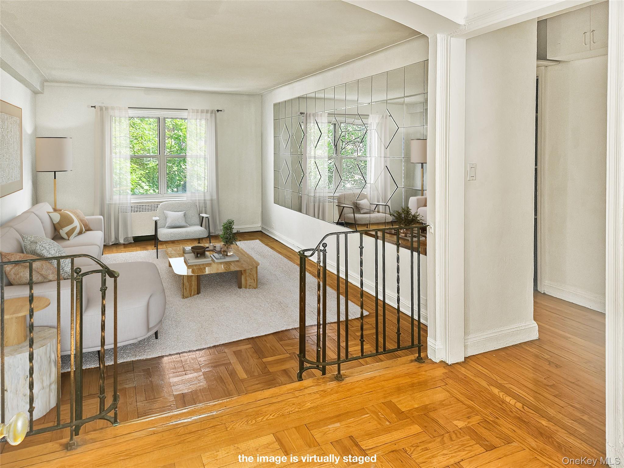 72-15 37th Avenue, Unit 3H Queens, NY 11372 - Photo 1 of 14 Living area featuring arched walkways and radiator