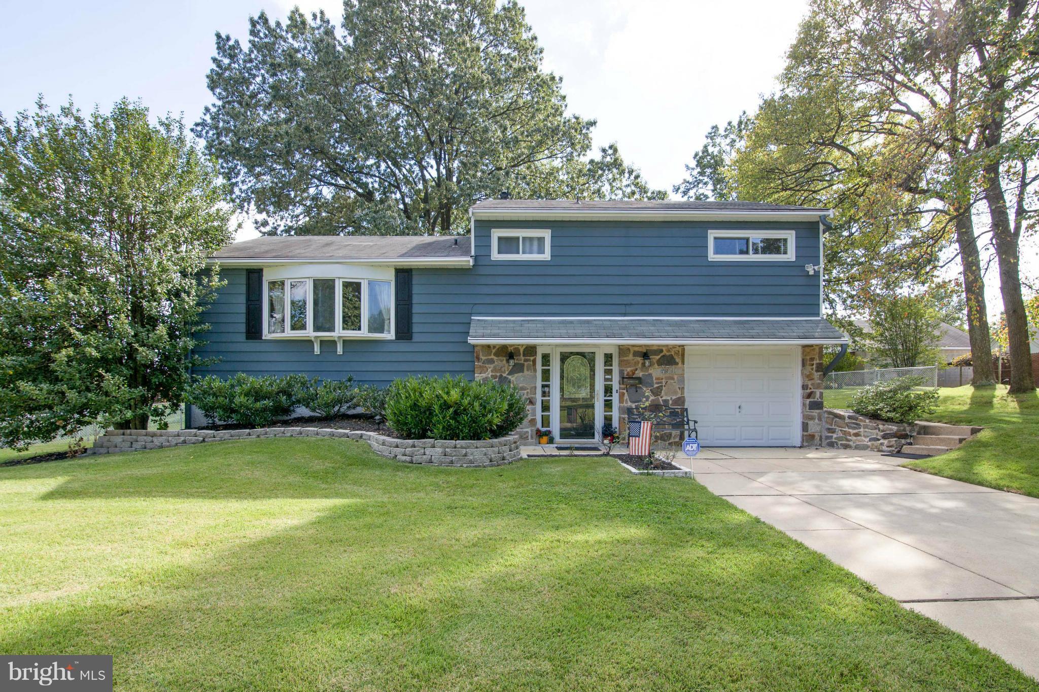 a view of a house with a yard and sitting area