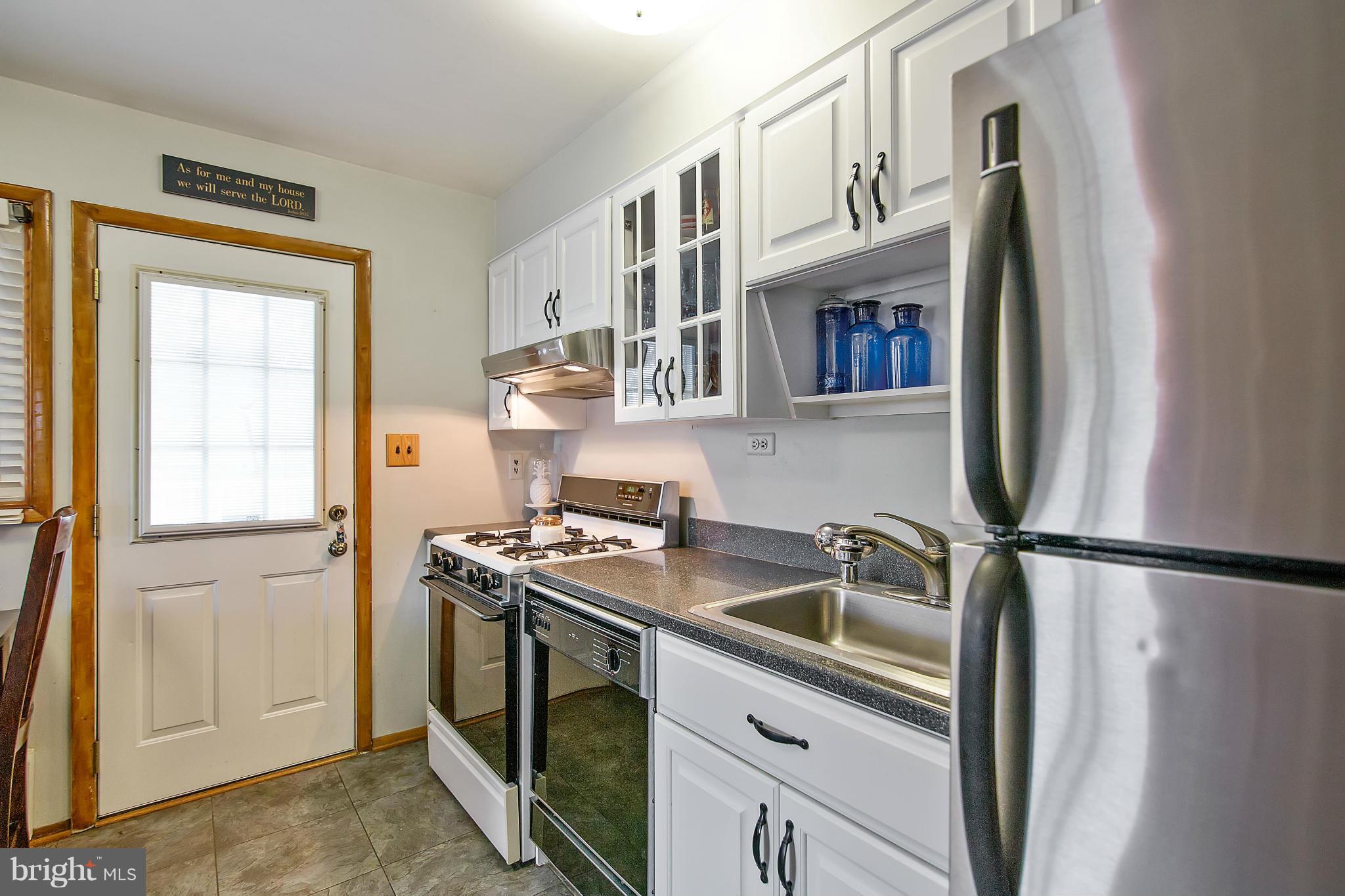 451 West Maple Road Linthicum Heights, MD 21090 - Photo 12 of 30 a kitchen with stainless steel appliances granite countertop a refrigerator a sink and a stove
