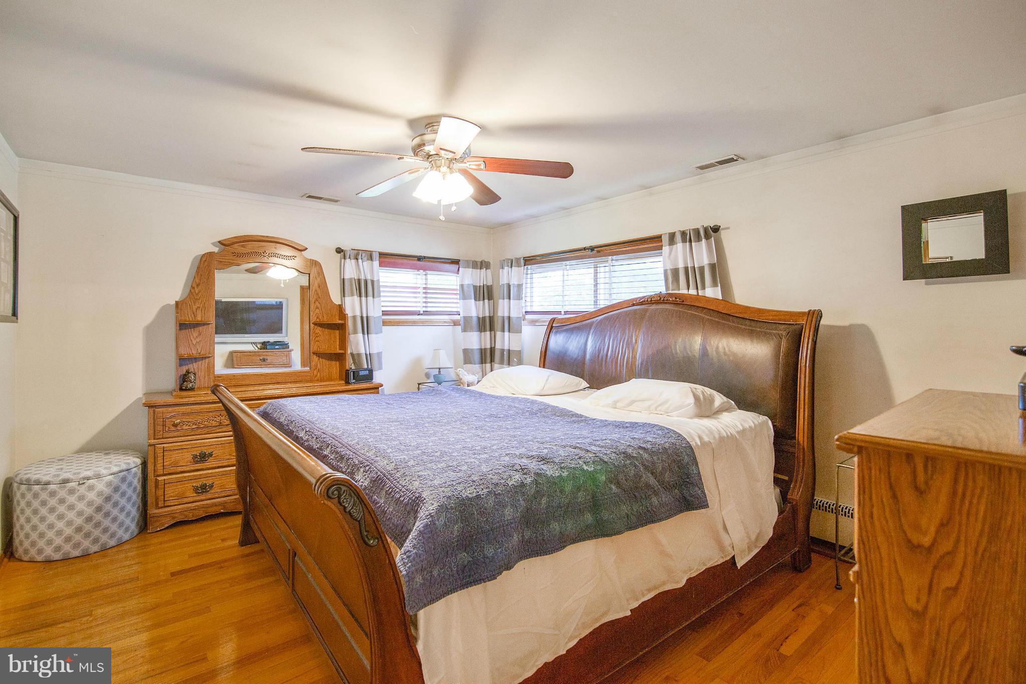 451 West Maple Road Linthicum Heights, MD 21090 - Photo 17 of 30 a bedroom with a bed and a chandelier
