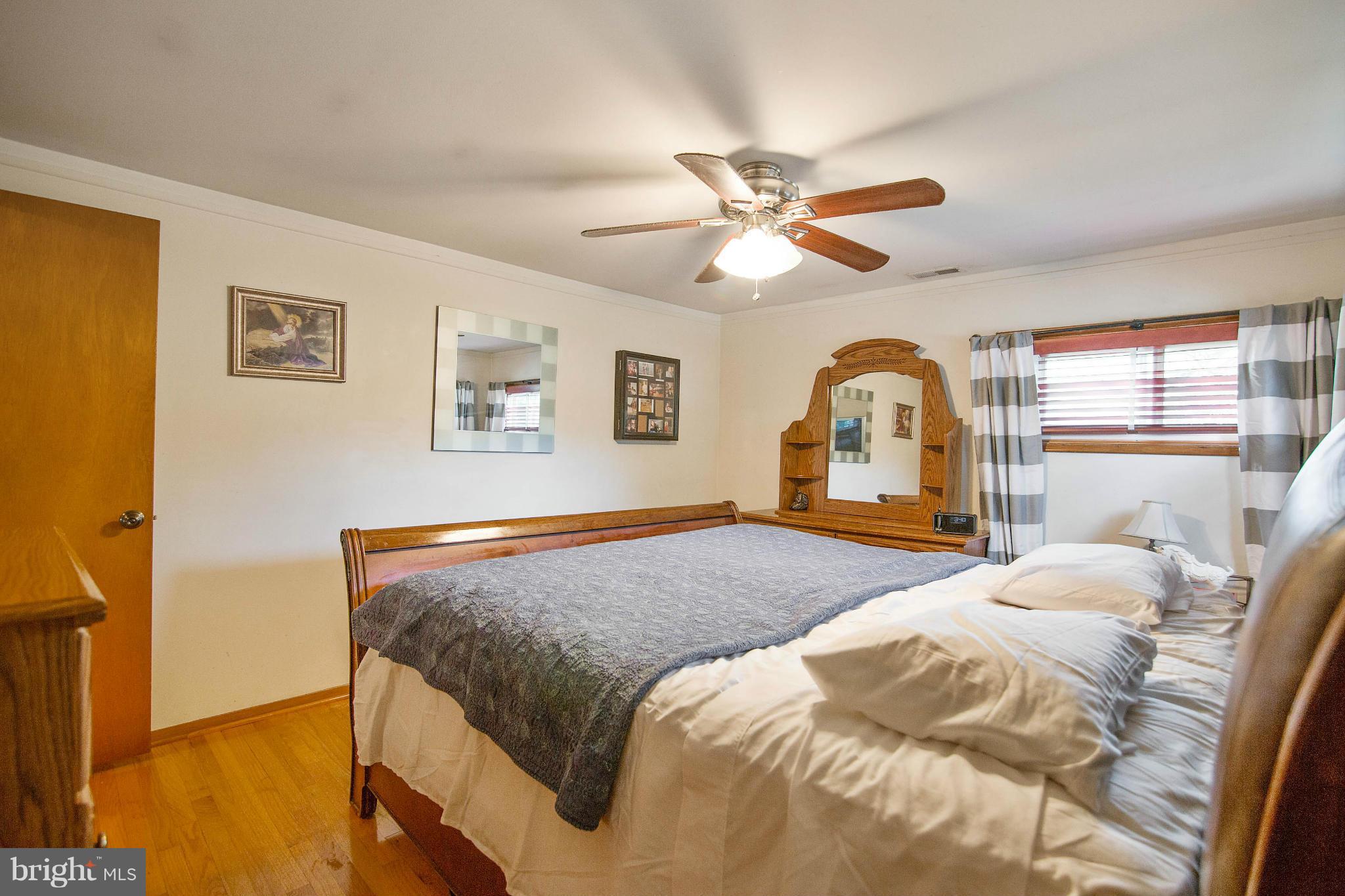 451 West Maple Road Linthicum Heights, MD 21090 - Photo 18 of 30 a bedroom with a large bed and a chandelier