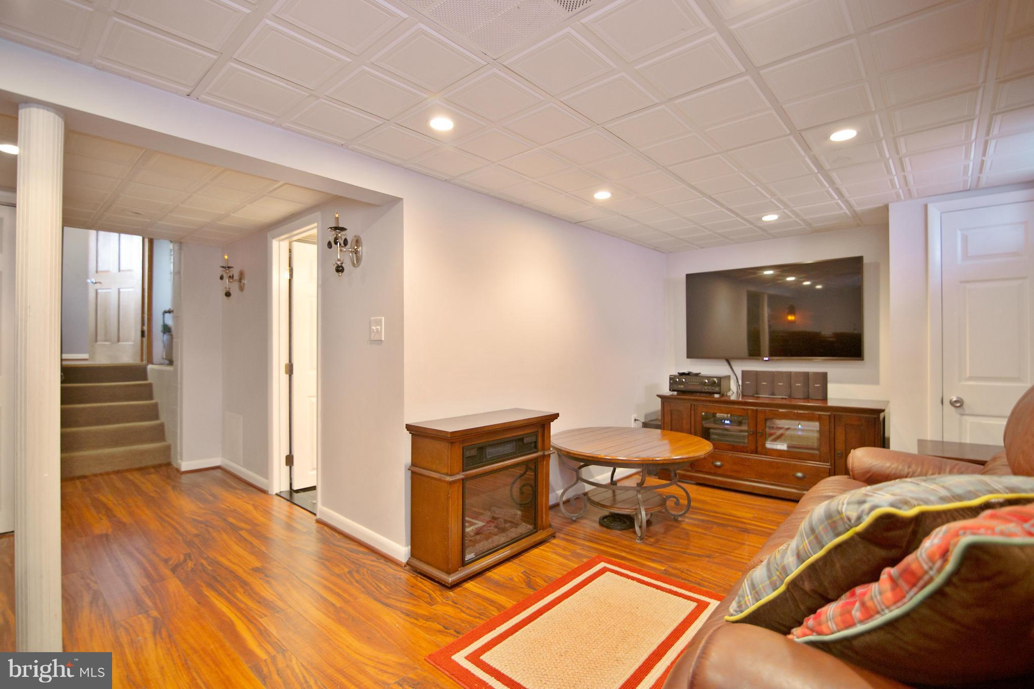 451 West Maple Road Linthicum Heights, MD 21090 - Photo 26 of 30 a living room with furniture a flat screen tv and kitchen view
