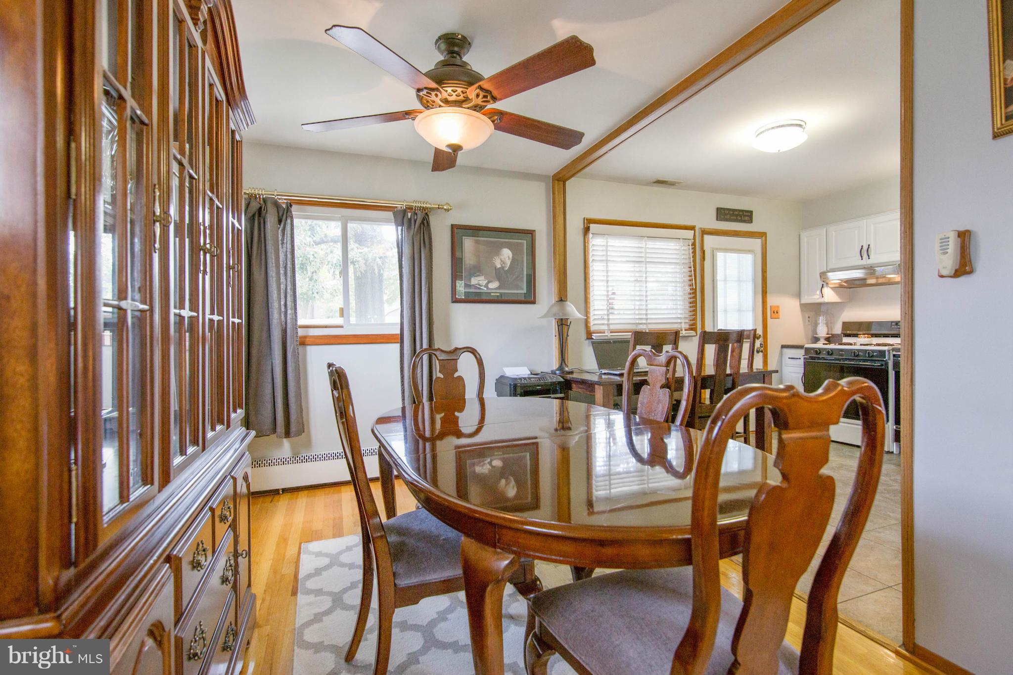 451 West Maple Road Linthicum Heights, MD 21090 - Photo 10 of 30 a view of a dining room with furniture a chandelier and large windows