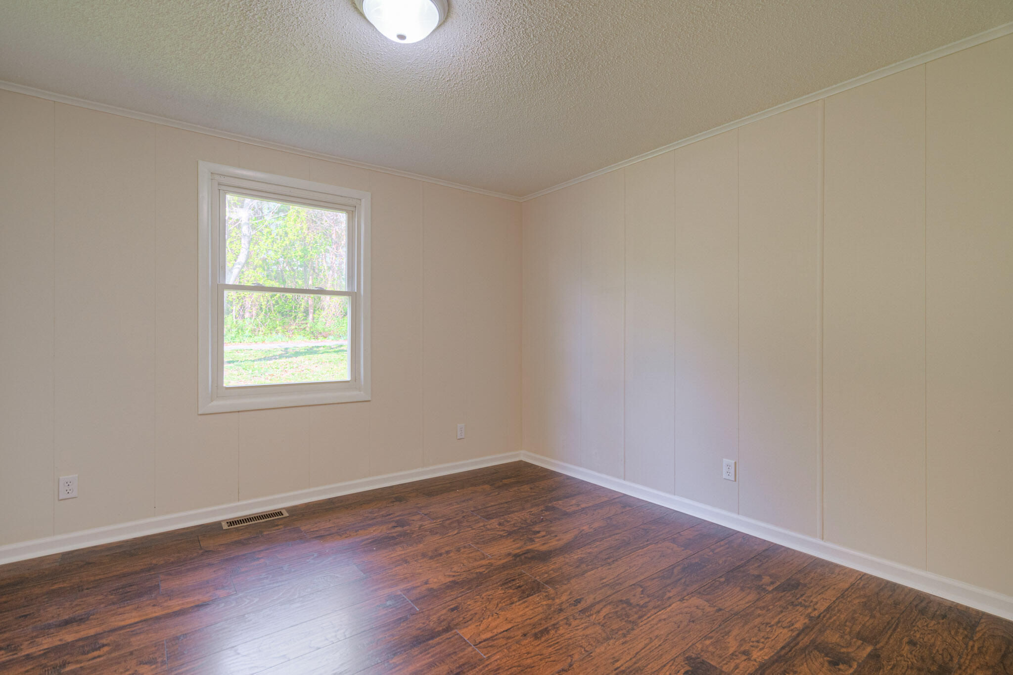 5216 Colonial Drive Dublin, VA 24084 - Photo 17 of 31 an empty room with wooden floor and windows