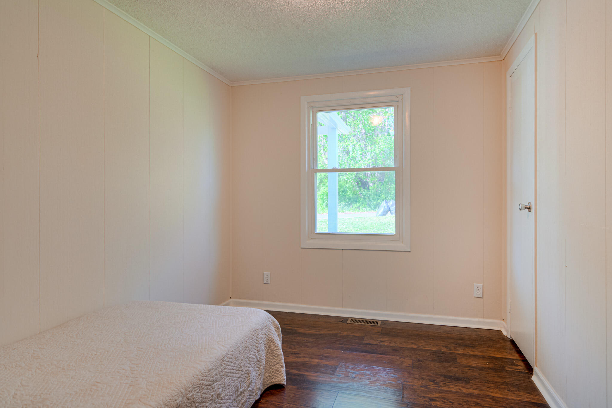 5216 Colonial Drive Dublin, VA 24084 - Photo 23 of 31 an empty room with wooden floor and windows