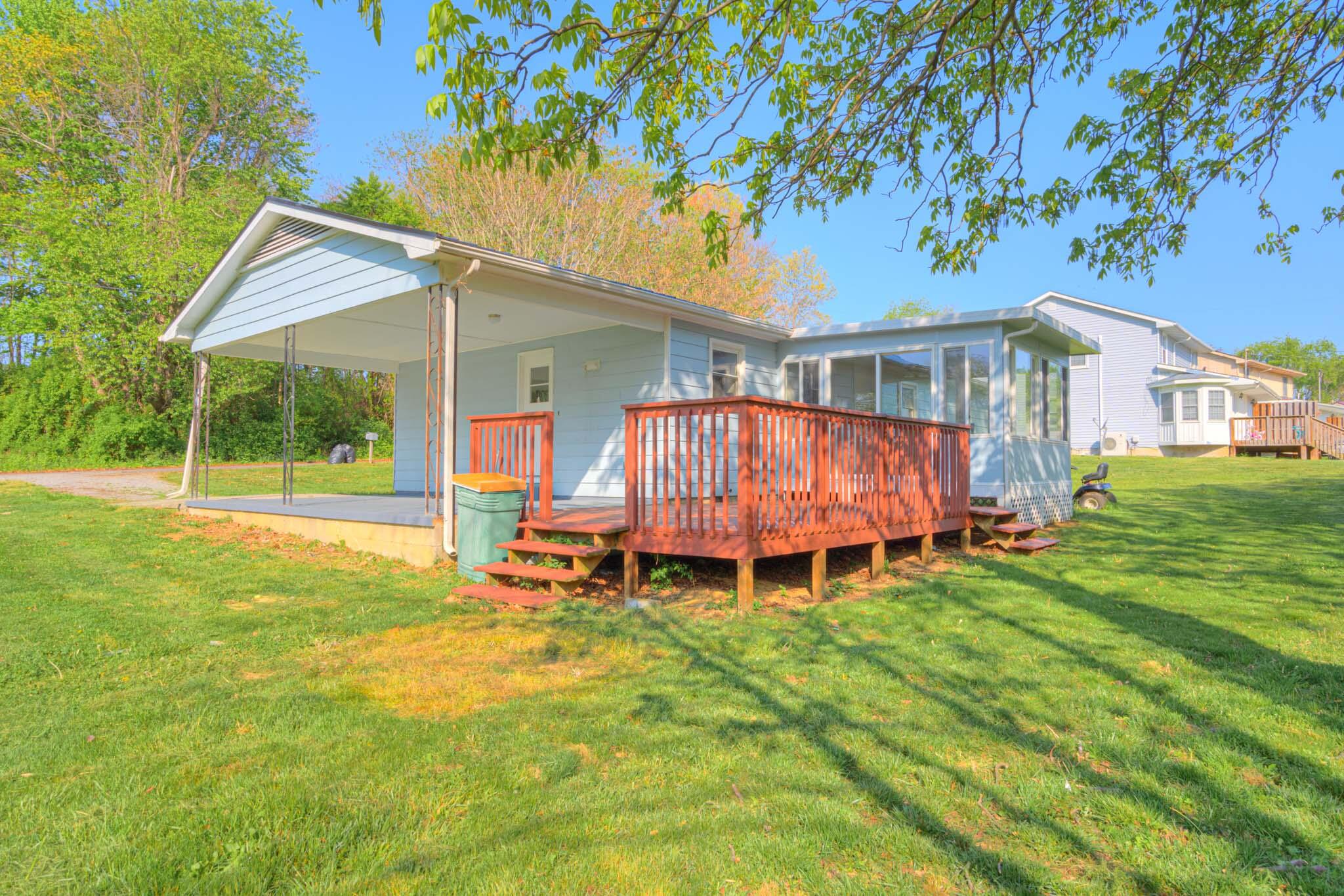 5216 Colonial Drive Dublin, VA 24084 - Photo 3 of 31 a front view of a house with a yard table and chairs