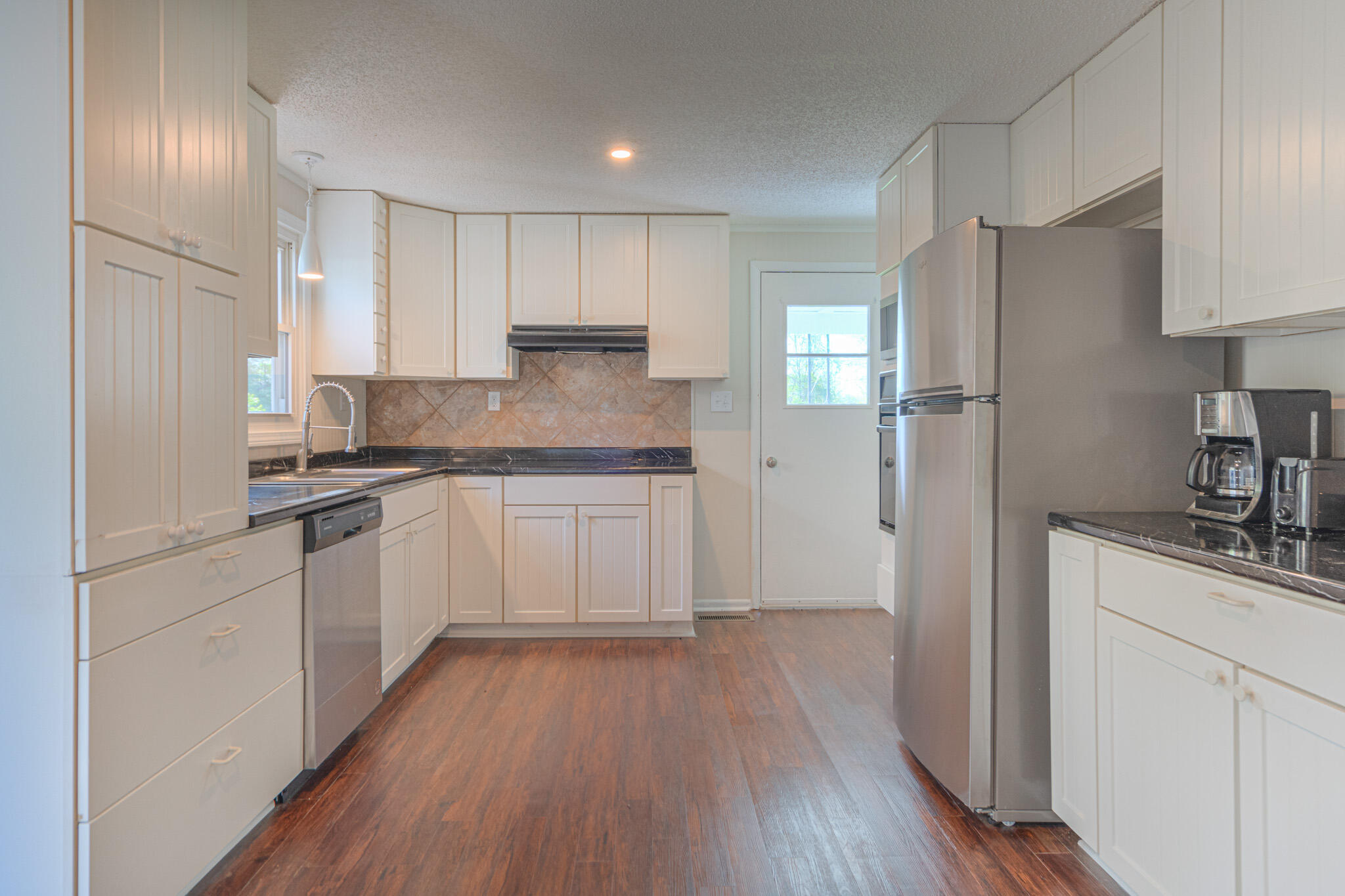 5216 Colonial Drive Dublin, VA 24084 - Photo 8 of 31 a kitchen with a refrigerator a sink and wooden floor