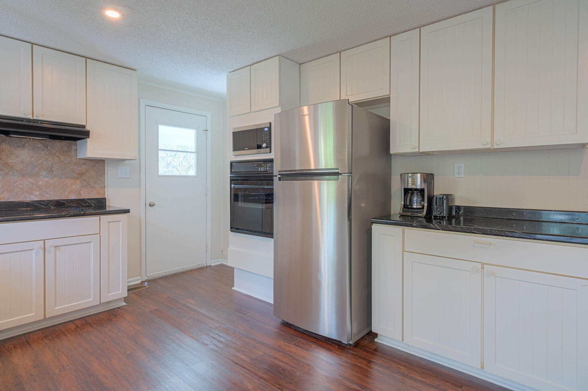 5216 Colonial Drive Dublin, VA 24084 - Photo 9 of 31 a kitchen with a refrigerator sink and cabinets