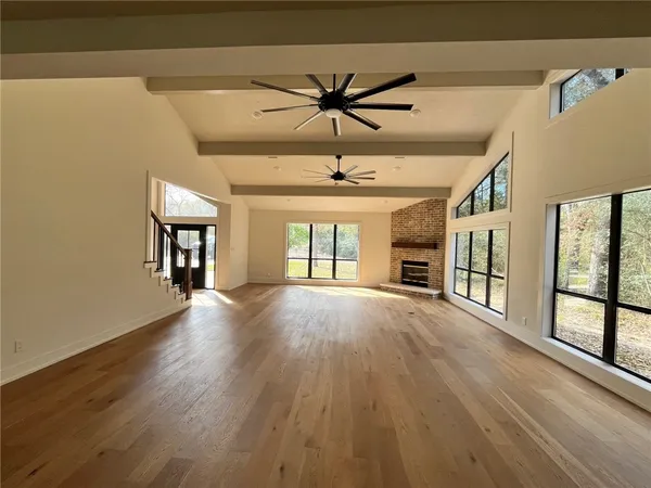 a view of a livingroom with a ceiling fan and window