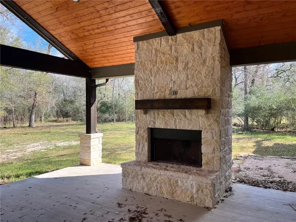 a living room with a fireplace and a floor to ceiling window