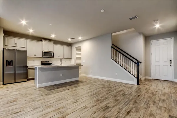 a large kitchen with stainless steel appliances granite countertop a large counter top and a stove top oven