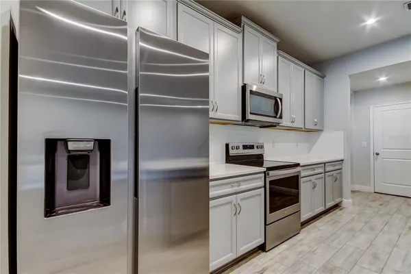 a kitchen with stainless steel appliances granite countertop a stove and a microwave