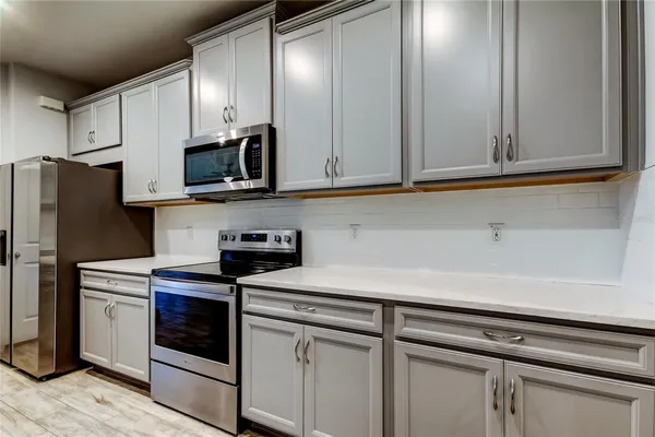 a kitchen with stainless steel appliances white cabinets and a sink
