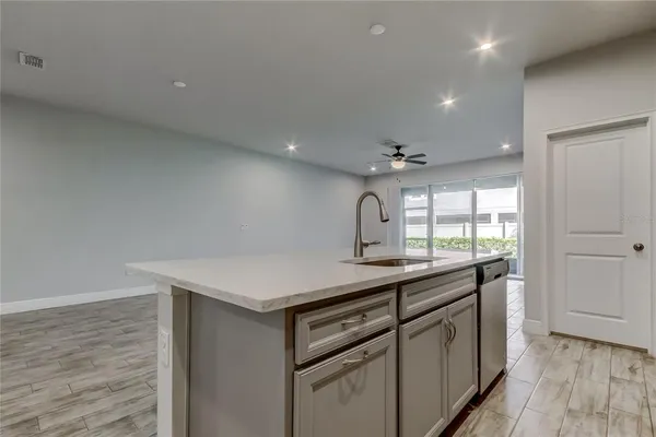 a kitchen with a sink dishwasher a stove and a refrigerator with wooden floor
