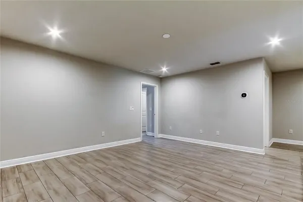 a view of room with wooden floor