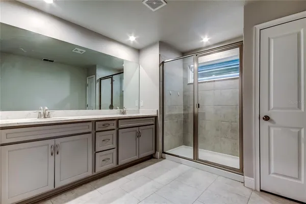 a bathroom with a double vanity sink and mirror