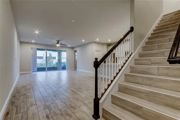 a view of staircase with wooden floor and white walls