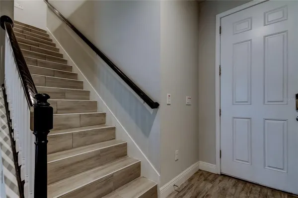 a view of entryway and gallery with wooden floor