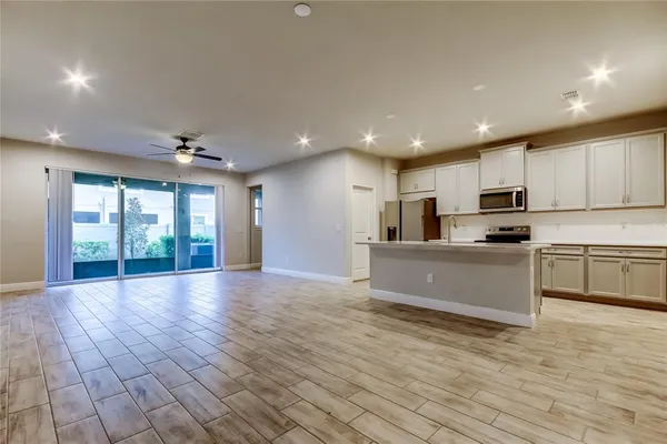 a kitchen with stainless steel appliances granite countertop a stove a sink and a refrigerator