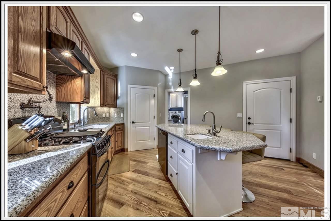170 Granite Drive Stateline, NV 89449 - Photo 11 of 25 a kitchen with stainless steel appliances granite countertop a sink a stove and a wooden floors