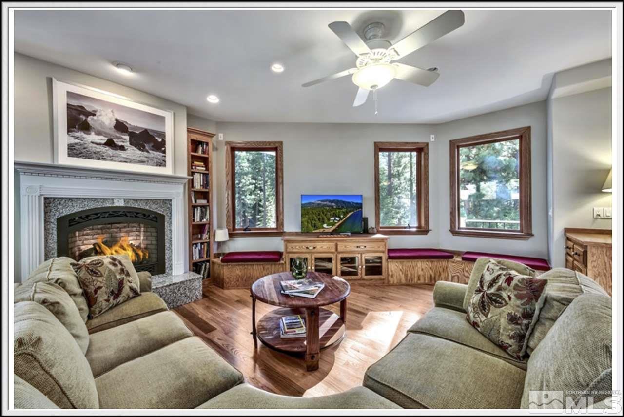 170 Granite Drive Stateline, NV 89449 - Photo 5 of 25 a living room with furniture a fireplace and a large window