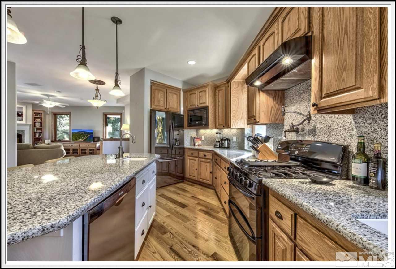 170 Granite Drive Stateline, NV 89449 - Photo 9 of 25 a kitchen with stainless steel appliances granite countertop a sink a stove and a wooden floors
