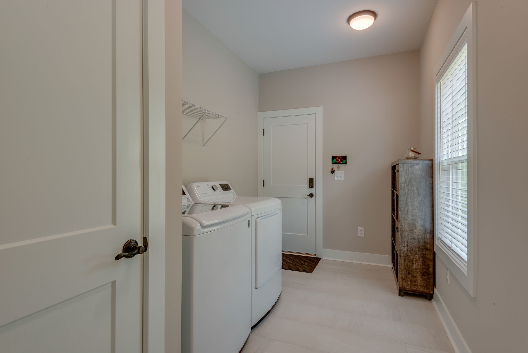 26 Sycamore Ridge West Burns, TN 37029 - Photo 16 of 23 a view of a hallway with washer and dryer