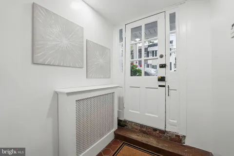 a view of an entryway with wooden floor