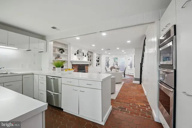 a kitchen with sink a stove and cabinets