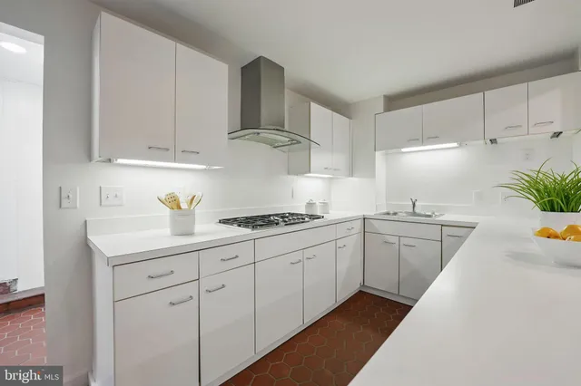 a kitchen with stainless steel appliances a sink stove and refrigerator