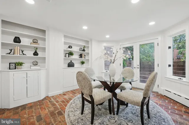 a living room with furniture a fireplace and a table