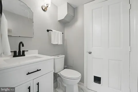 a living room with furniture a fireplace and a table