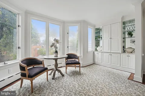 a living room with furniture a fireplace and a table