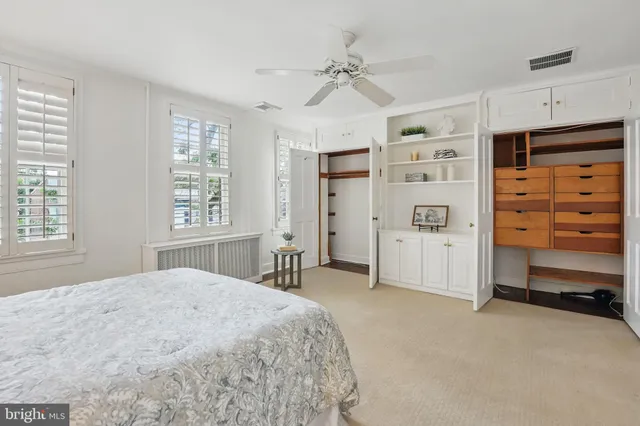 a spacious bedroom with a bed and a window