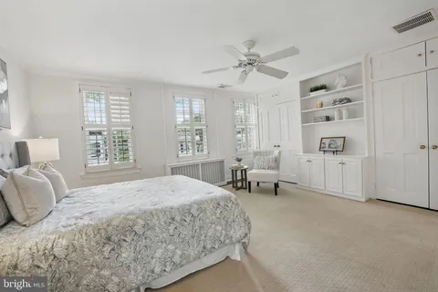 a spacious bedroom with a bed and a window