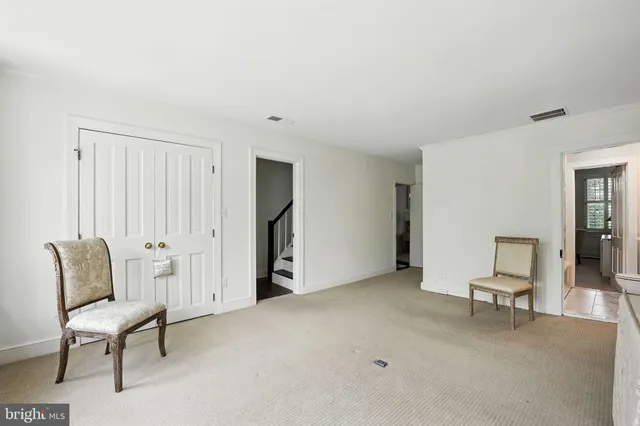 a view of a bedroom with wooden floor and a window