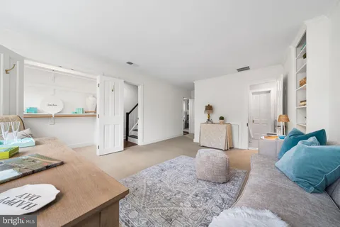 a view of staircase with wooden floor and white walls