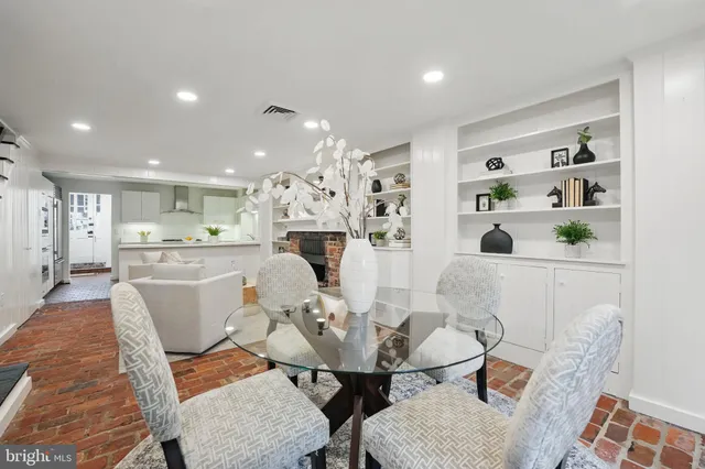 a dining room with furniture a chandelier and wooden floor