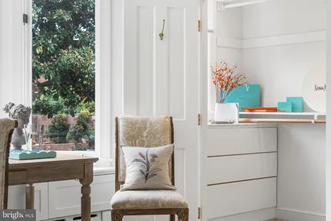 a view of a bedroom with wooden floor and a window