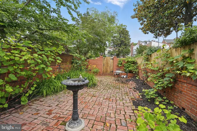 a view of a house with a yard and potted plants