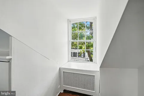 a view of a white house with a sink and table in a patio