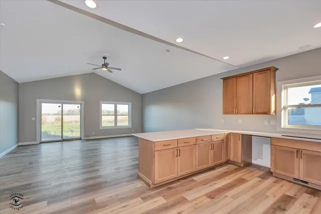 a kitchen with white cabinets and sink