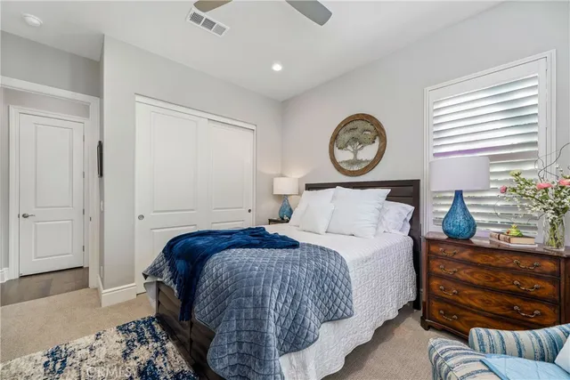 a bedroom with furniture and a large window