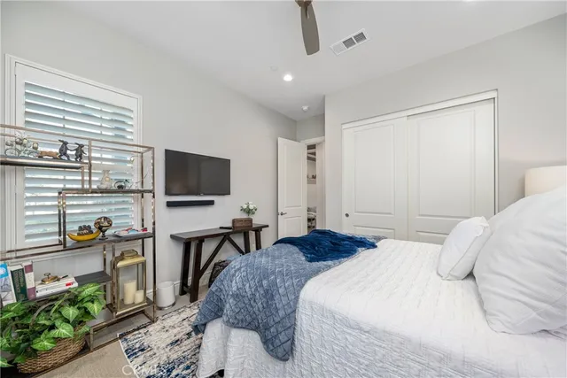 a bedroom with furniture and a flat screen tv