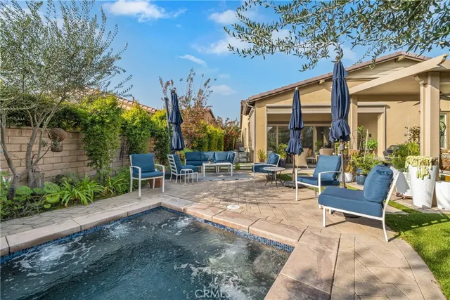 a living room with patio furniture and a large window
